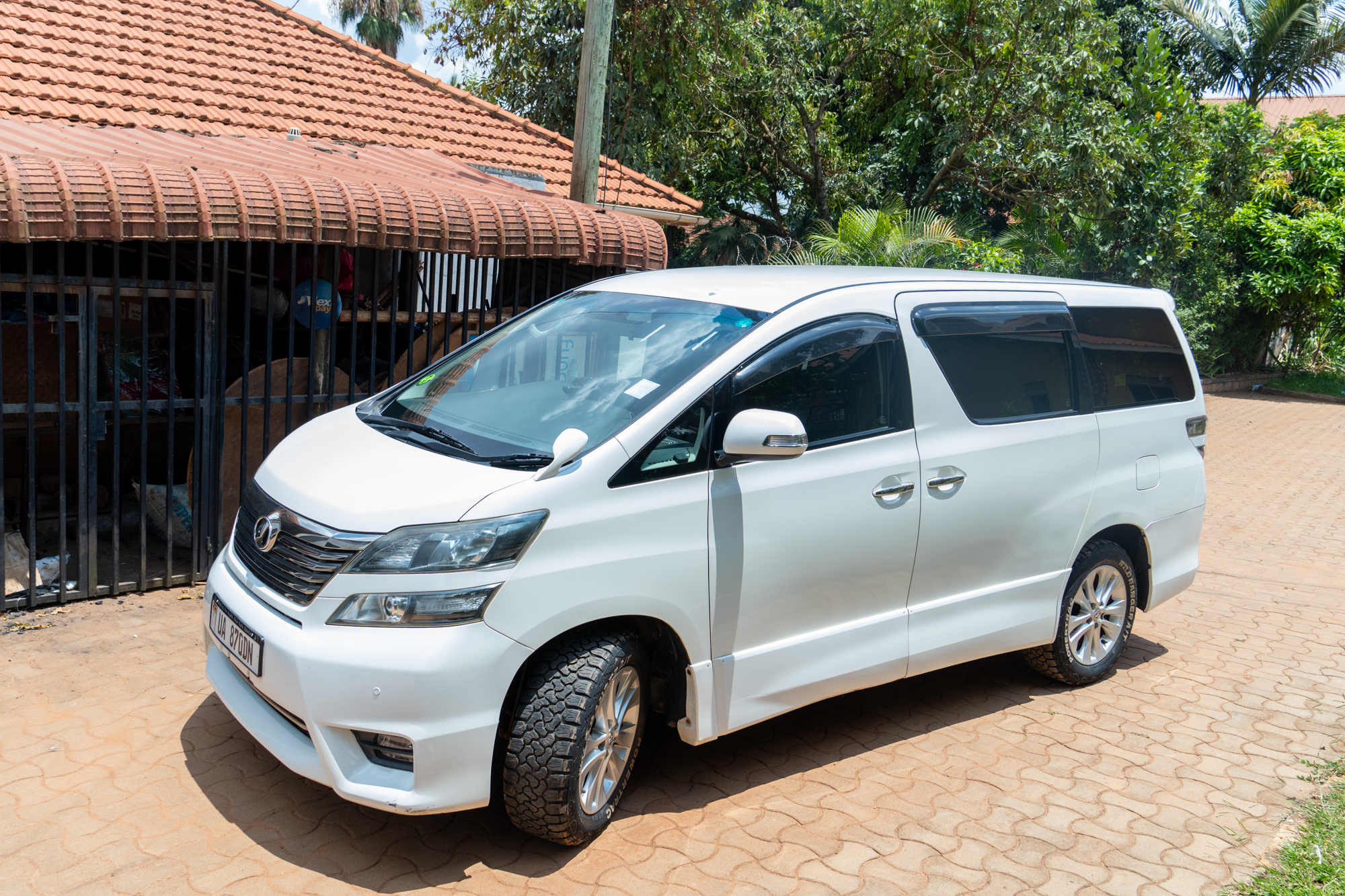 Fourthwind pearl white Toyota Vellfire parked in Kampala